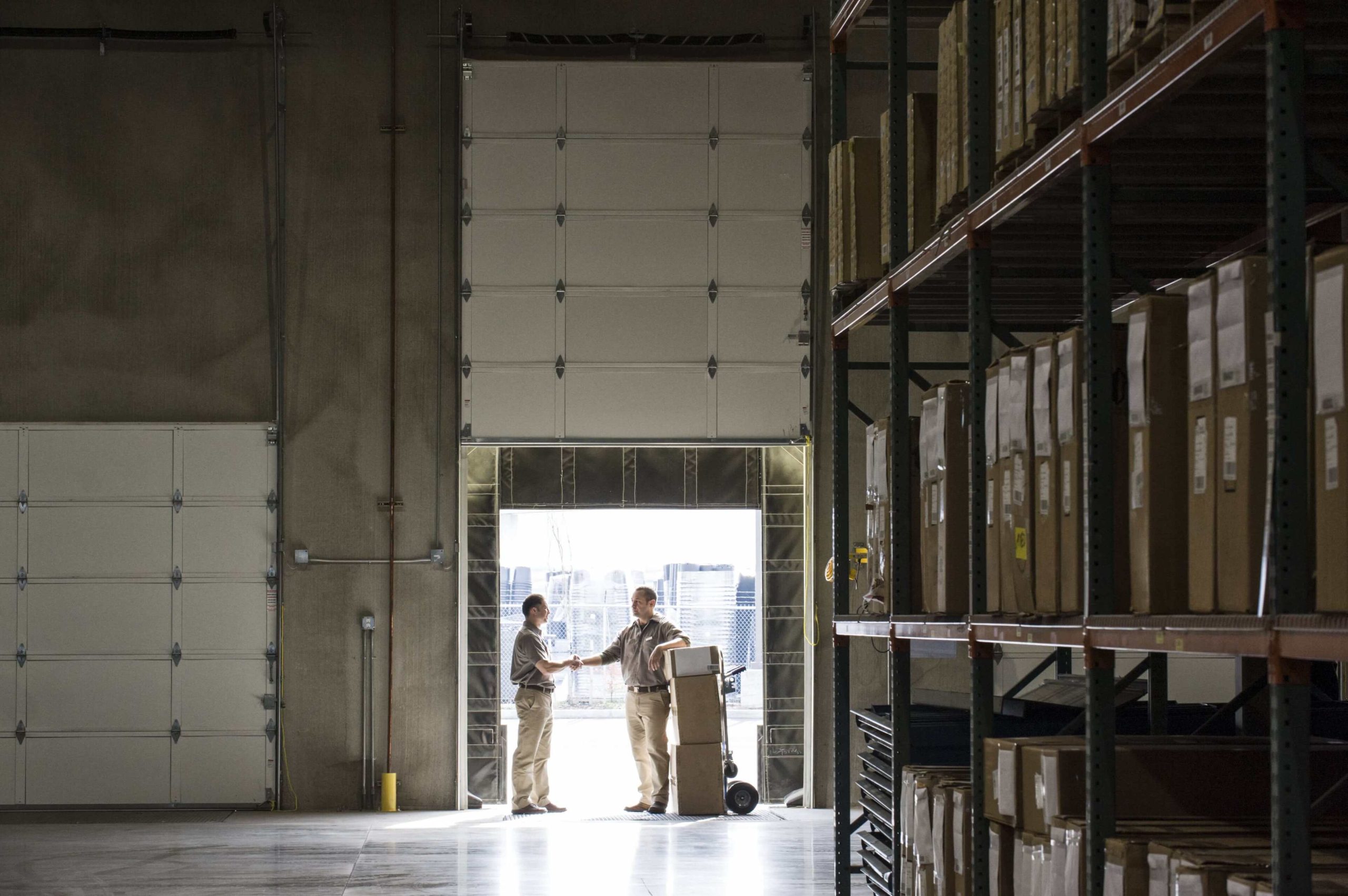 Two warehouseworkers shaking hands in the door of 2025 04 04 08 10 40 utc min (1)